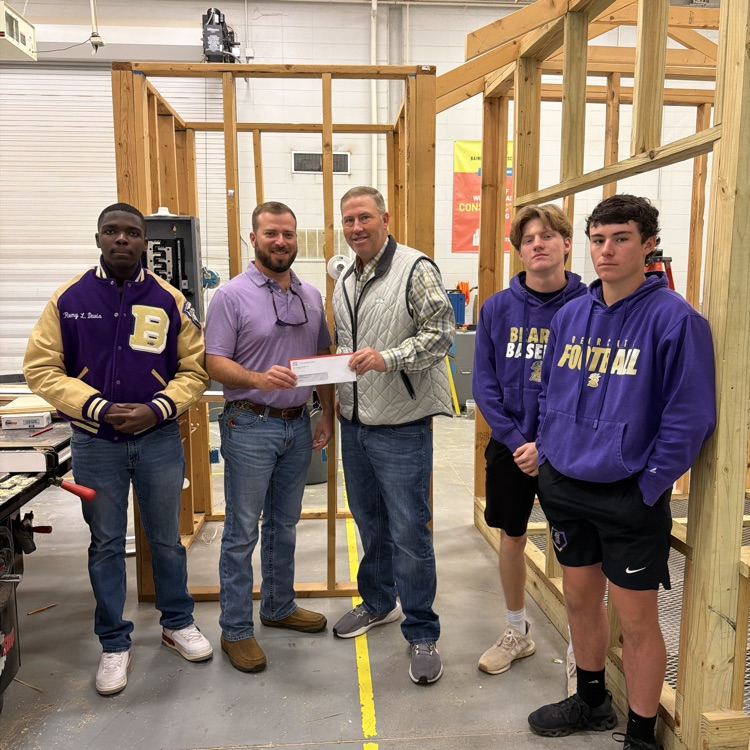 Mr. Jayson Myers presenting a check to Mr. Greg Harrell for the BHS Construction Dept. 