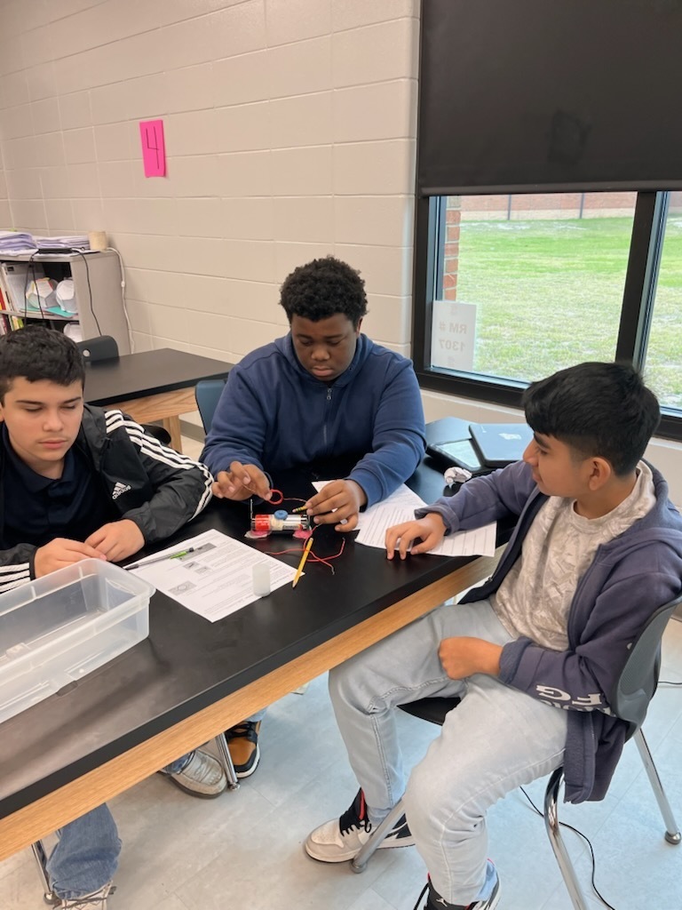 students work together  in lab classroom setting on motor design 