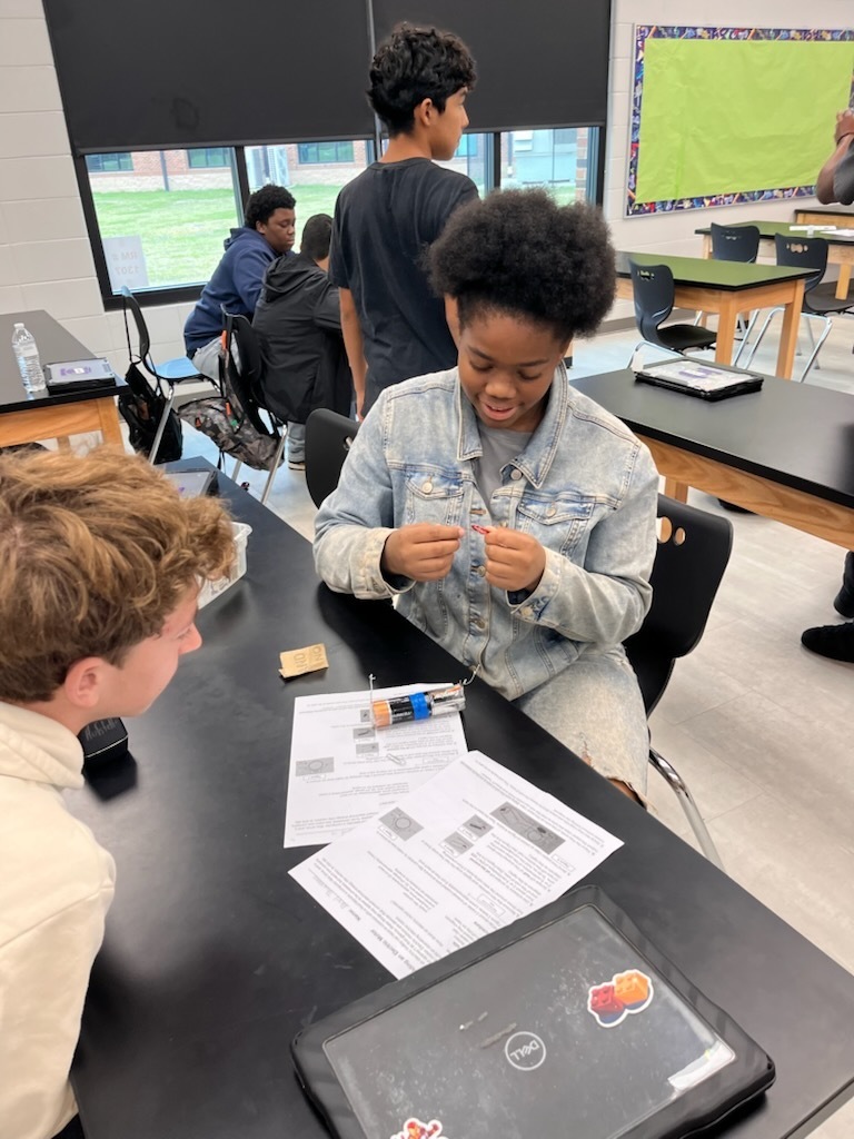 students work together  in lab classroom setting on motor design 