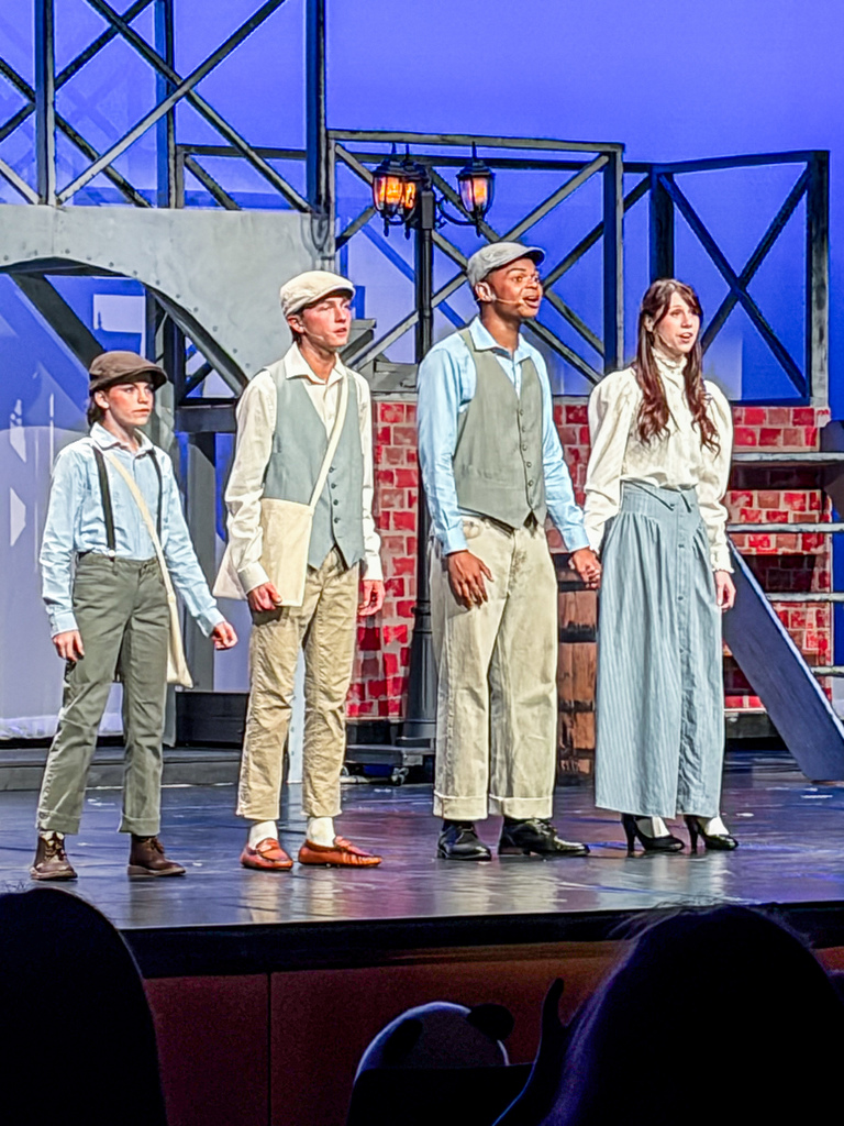 Cast of Newsies Jr. - Leads singing on stage