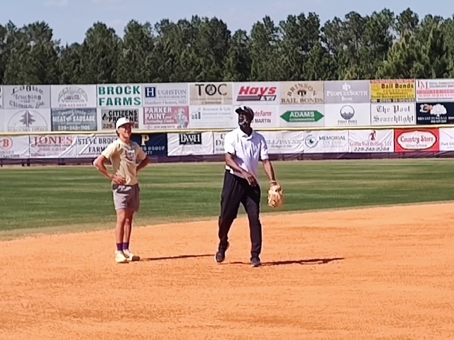 Alum Ernest Riles giving some pointers to Bearcats starting shortstop Benji Dollar.
