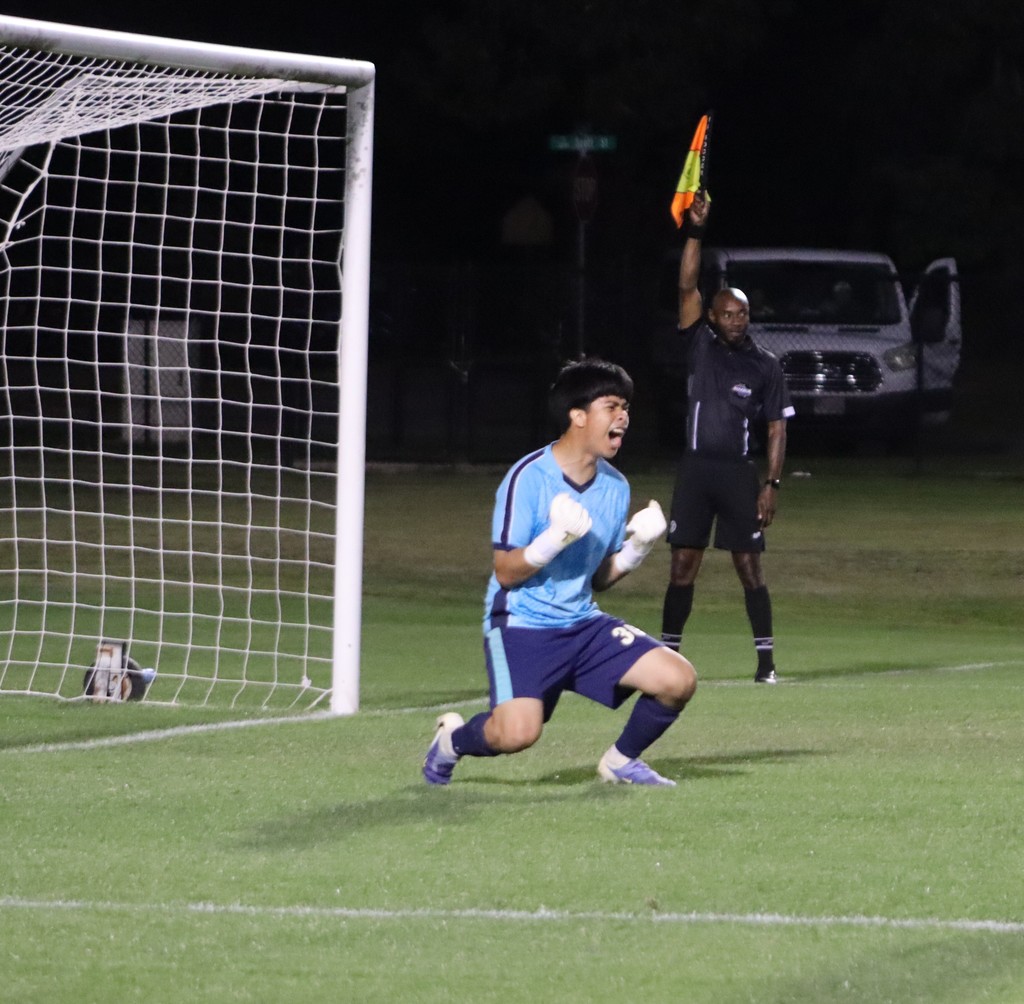 bhs soccer player dressed in purple uniform plays game taking on opponent in white uniform