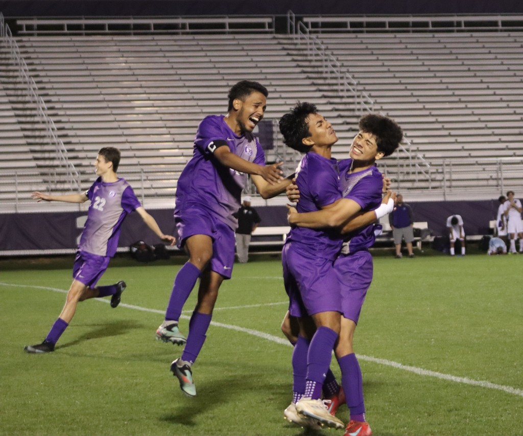 bhs soccer player dressed in purple uniform plays game taking on opponent in white uniform