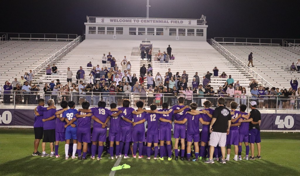 bhs soccer player dressed in purple uniform plays game taking on opponent in white uniform