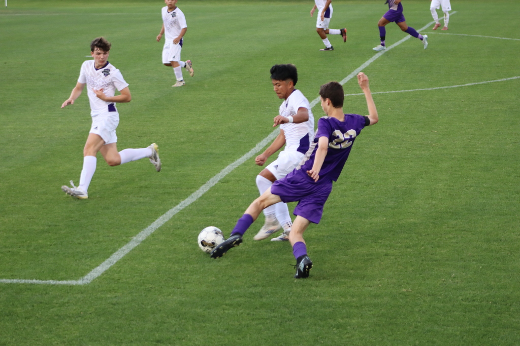 bhs soccer player dressed in purple uniform plays game taking on opponent in white uniform