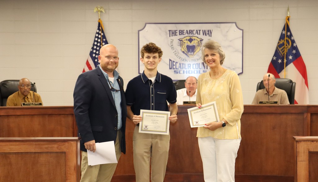 Bainbridge High School Principal Christopher Bryant presents the STAR Student and STAR Teacher award to Mitchell Carter and Dr. Heidi Chambers. 