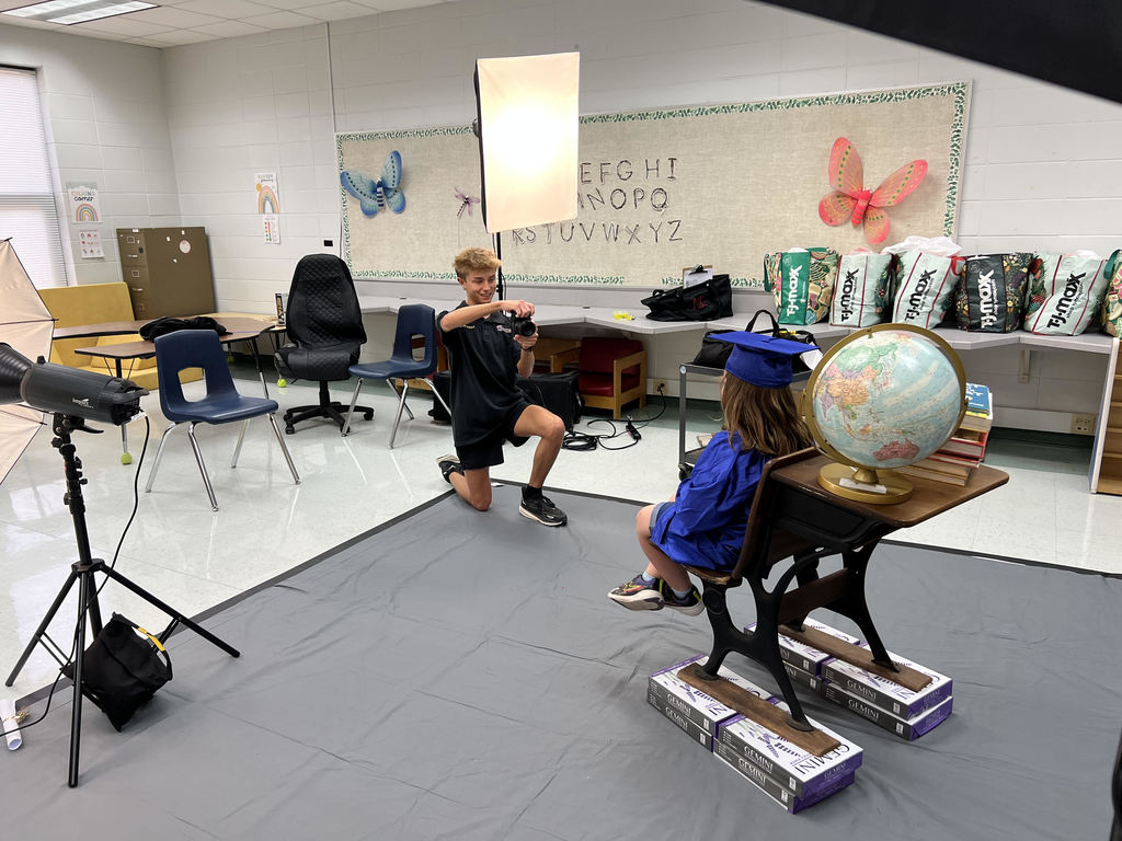 Bearcat Broadcasting member, Matthew Strickland, photographs a West Bainbridge Primary student.