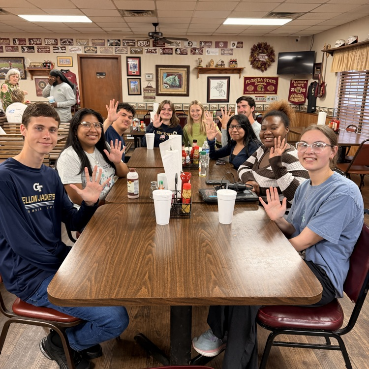 AP Lit students hold up the score they're going to make on the test after fueling up at Betty's.