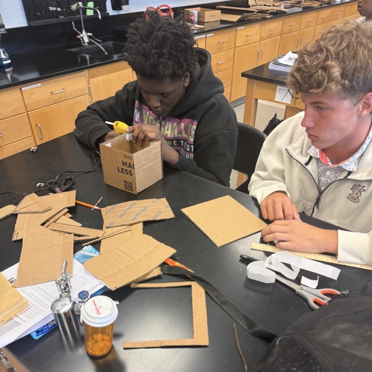 Students in Mrs. McDonald's Environmental Science classes designed, constructed, and tested structures that used wind and solar energy to power LED bulbs.