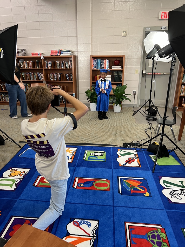 Bearcat Broadcasting student, Matthew Strickland, photographs a Jones Wheat Primary Kindergarten student.