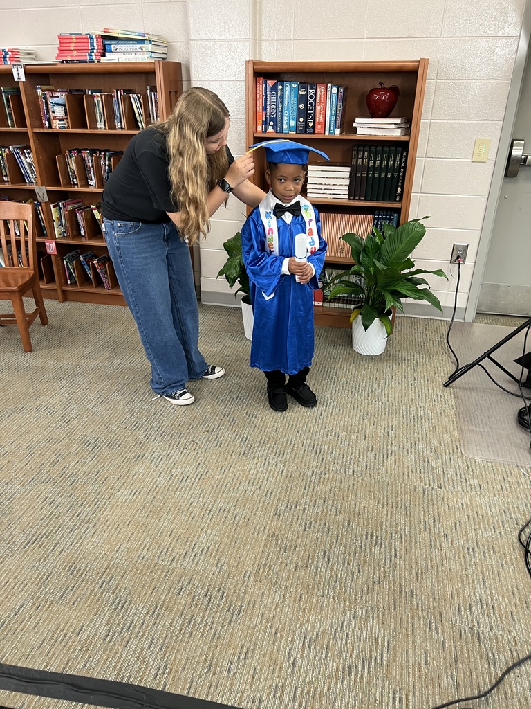 Bearcat Broadcasting student, Chloe Meredith, poses a Jones Wheat Primary Kindergarten student.