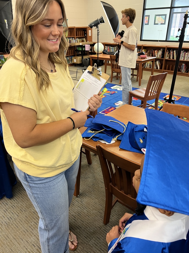 Bearcat Broadcasting student, Emsleigh Glass, checks in a Jones Wheat Primary Kindergarten student.