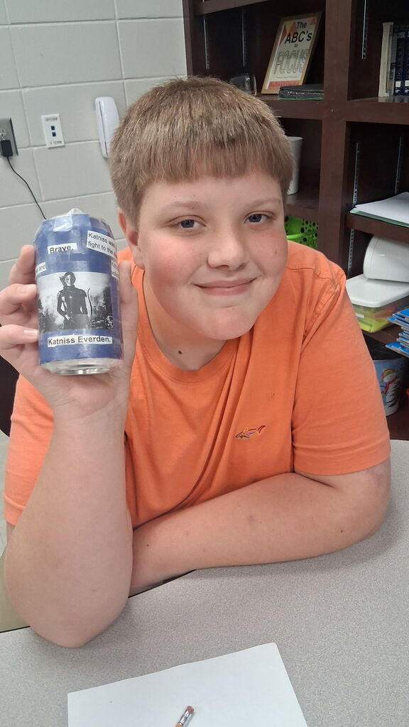 Students in Mrs. Crawford's class decorated empty soda cans describing characters in a story. 
