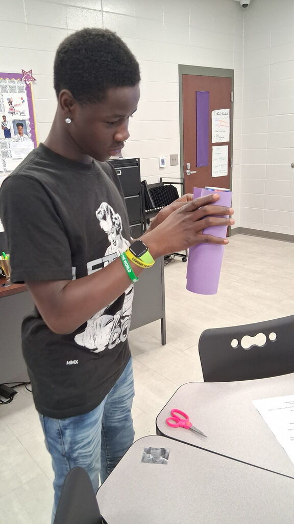 Students in Mrs. Crawford's class decorated empty soda cans describing characters in a story. 