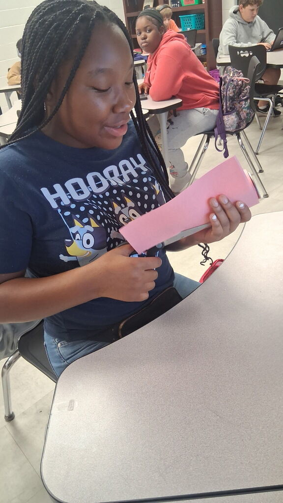Students in Mrs. Crawford's class decorated empty soda cans describing characters in a story. 