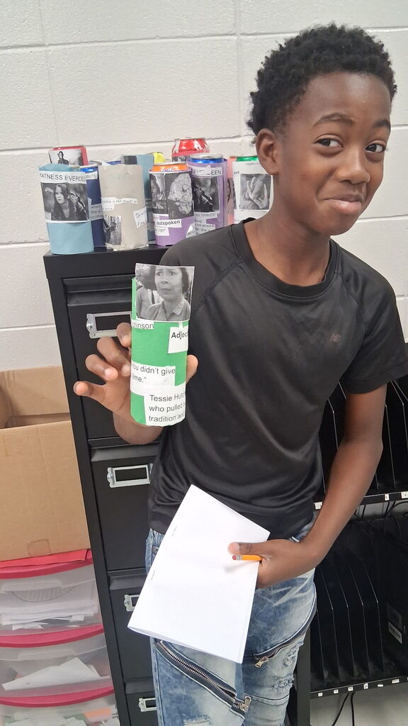 Students in Mrs. Crawford's class decorated empty soda cans describing characters in a story. 