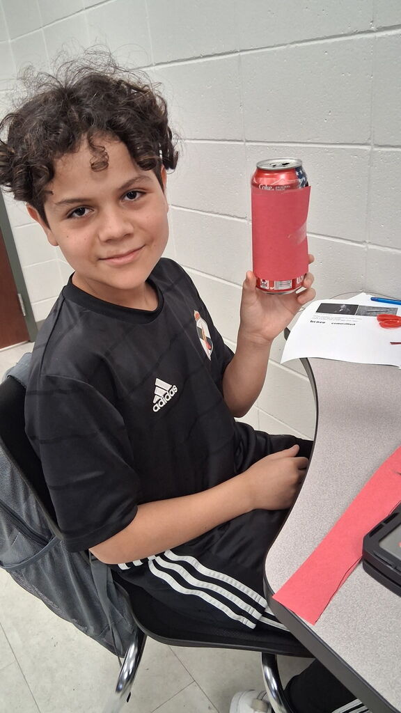 Students in Mrs. Crawford's class decorated empty soda cans describing characters in a story. 