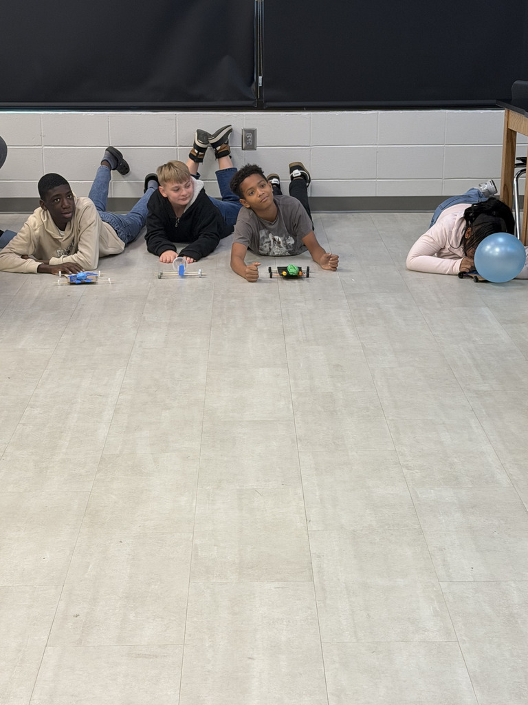 Student in Mr. Perry's Science class testing his project. Ready to race.
