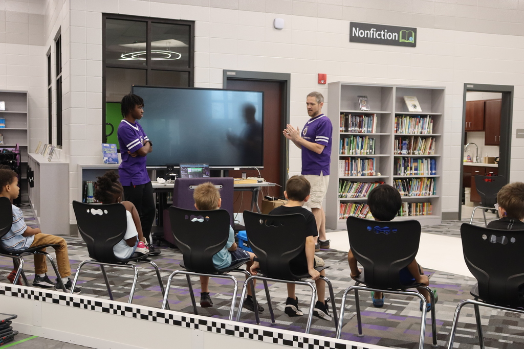 Students listen as STEM instructors introduce a robotics activity during Summer STEM Camp.