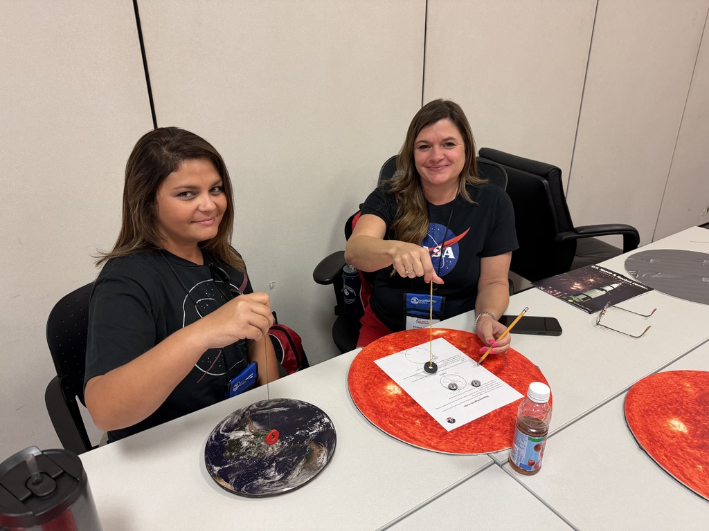 Two NASA HUNCH educators create watercolor galaxy paintings during a hands-on Lunch & Learn activity.