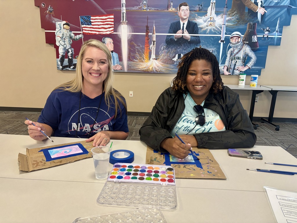 NASA HUNCH educators paint galaxy-themed watercolor artwork during a Lunch & Learn session about the Voyager missions.