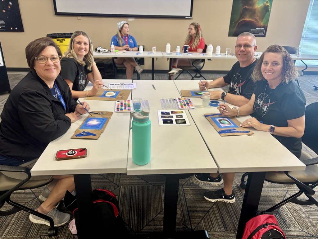 Two NASA HUNCH educators participate in a hands-on activity demonstrating the Earth-Sun relationship during Space Camp.