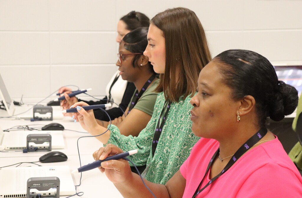 IMG_1080.JPG: New teachers use digital styluses during an interactive technology activity.