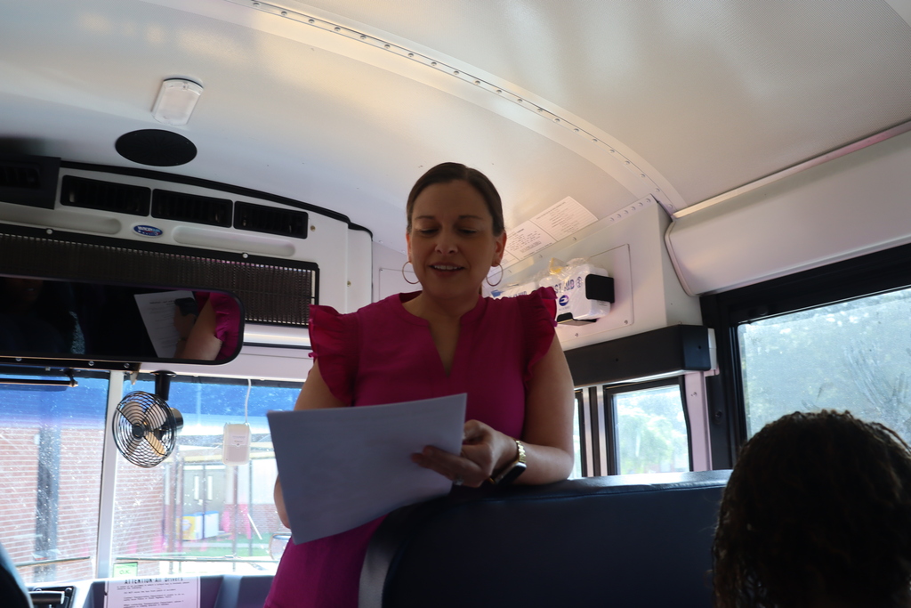 IMG_1013.JPG: A DCBOE director speaks to new teachers aboard a school bus.