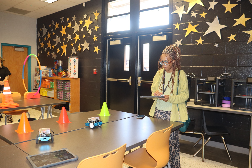 IMG_1005.JPG: A new teacher operates robots during a hands-on technology demonstration.