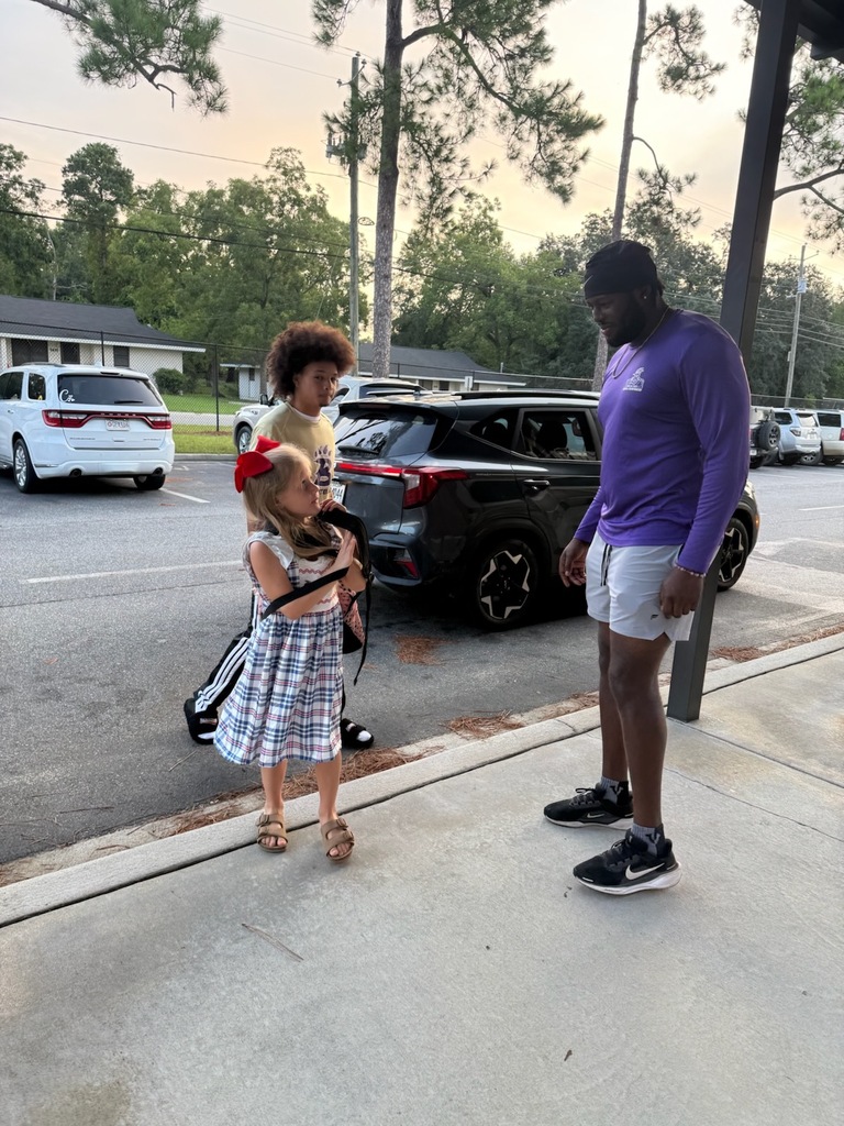 BHS football player welcomes young Bearcats on the first day of school.