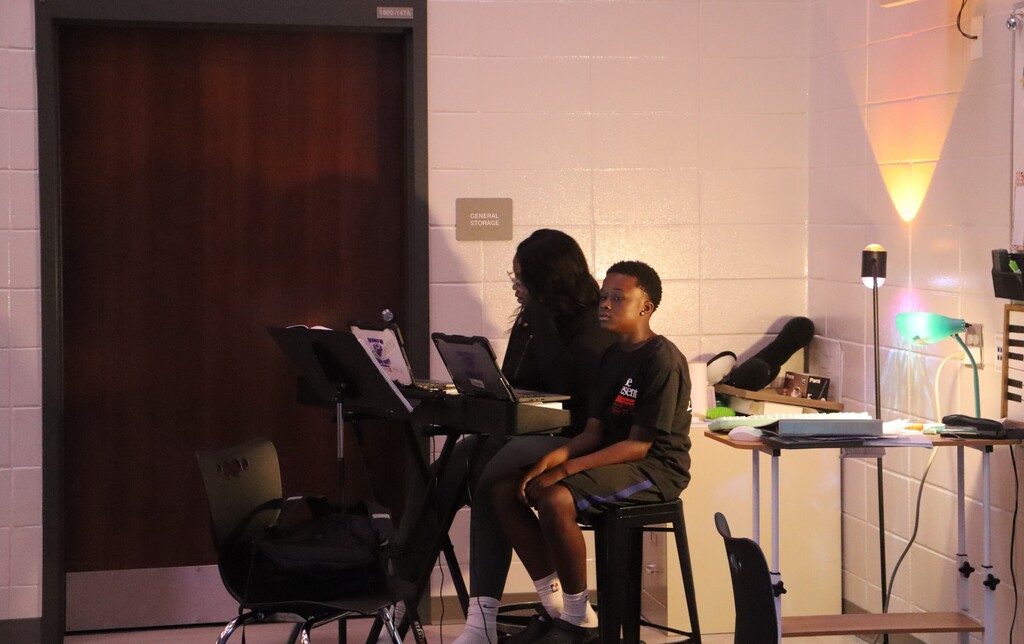 A Bainbridge Middle School student sits at a piano with an adult accompanist during auditions for the fall play.