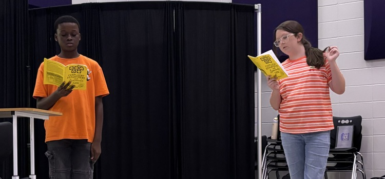 Two students learn their blocking and lines in the classroom