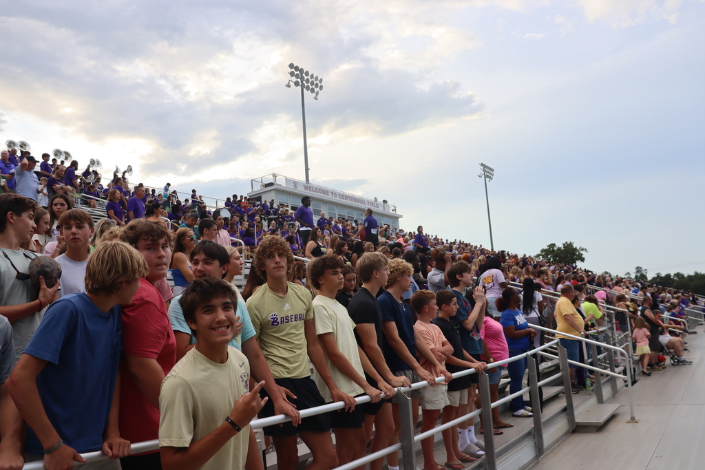 High school students, football players, cheerleaders, marching band members, and fans gather at Centennial Field for a Bearcats game day and school spirit event.