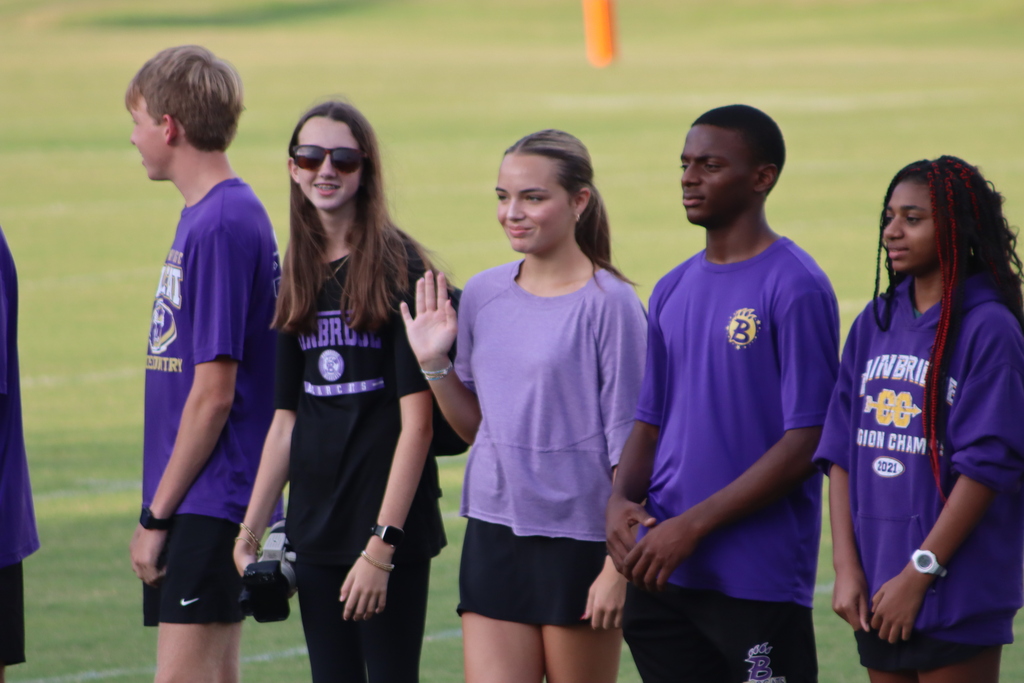 High school students, football players, cheerleaders, marching band members, and fans gather at Centennial Field for a Bearcats game day and school spirit event.