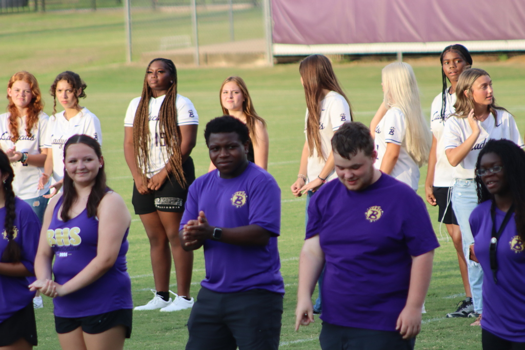 High school students, football players, cheerleaders, marching band members, and fans gather at Centennial Field for a Bearcats game day and school spirit event.