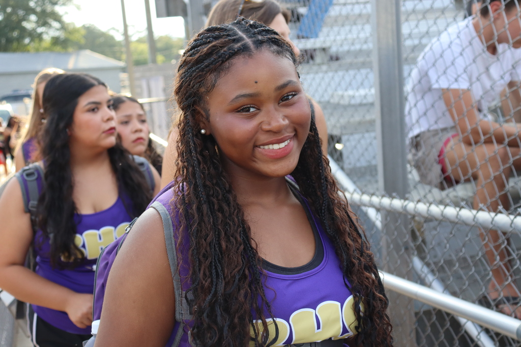 High school students, football players, cheerleaders, marching band members, and fans gather at Centennial Field for a Bearcats game day and school spirit event.