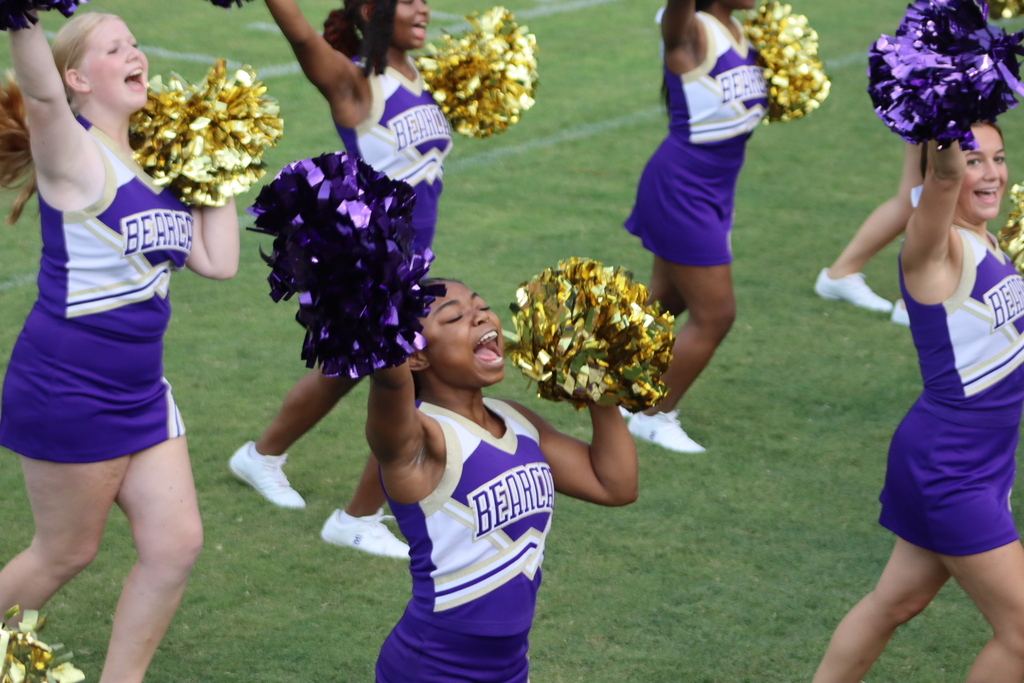 High school students, football players, cheerleaders, marching band members, and fans gather at Centennial Field for a Bearcats game day and school spirit event.