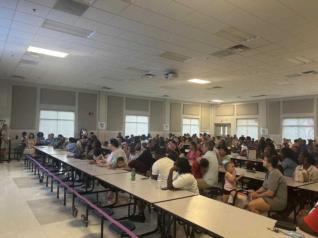 Families listen to important school information during Pre-K Orientation.