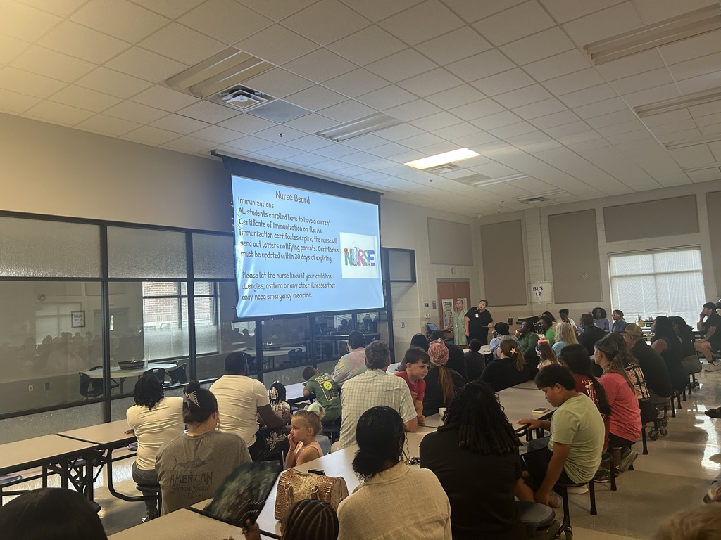 Pre-K families gather in the cafeteria for an orientation presentation.
