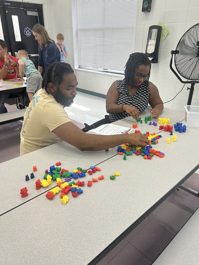 Families sort colorful counting bears during a hands-on Pre-K activity.