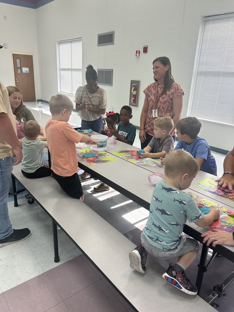 Children and families enjoy a Play-Doh activity together during Pre-K Orientation.