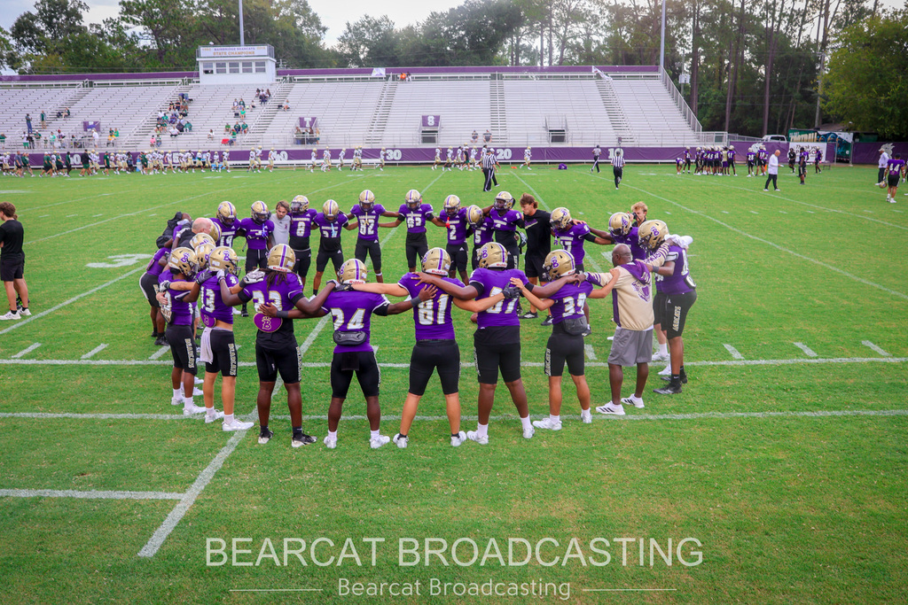 Bearcats huddle before the game begins