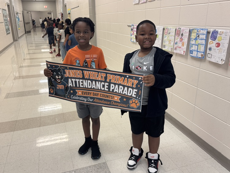 Mathias and Ky’Ree carrying the perfect attendance banner!🎉