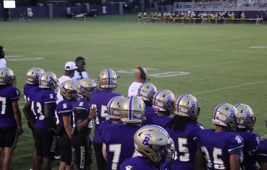 Bainbridge Bearcat football players gather on the sideline during the game.