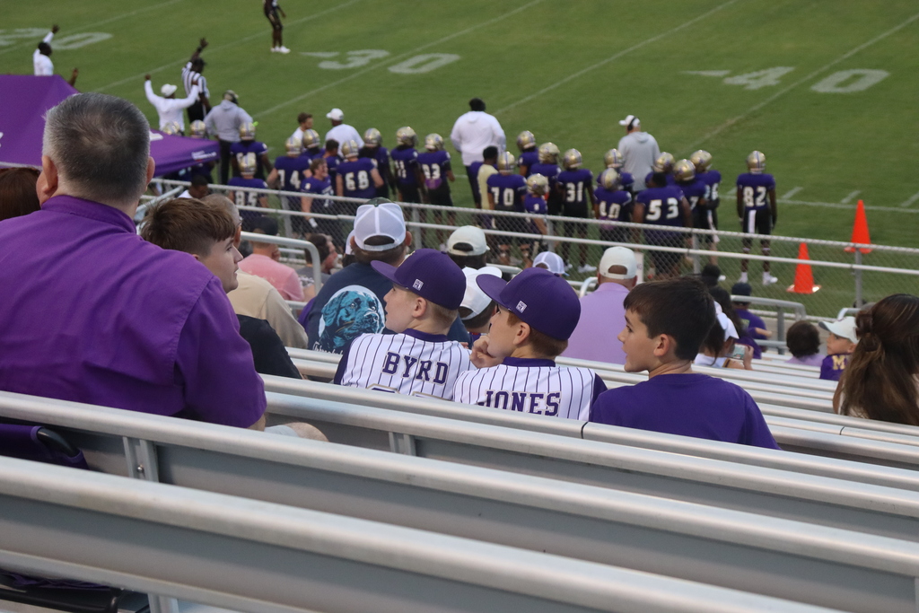 Young Bearcat fans watch the football game from the bleachers.