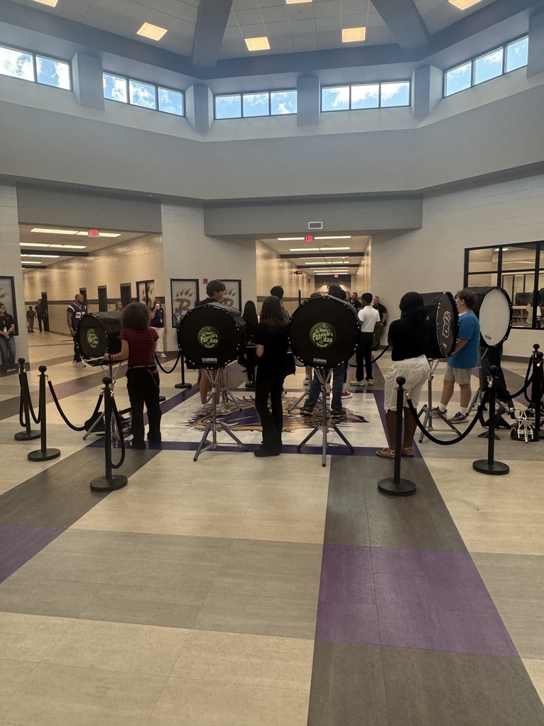 Photos from Bainbridge Middle School’s Homecoming Pep Rally featuring cheerleaders, students showing school spirit, and the BMS drumline performing in purple and gold.