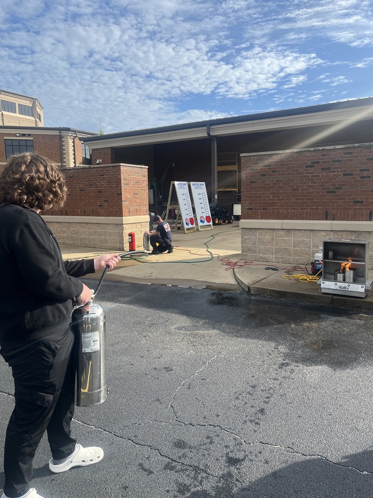 Students in the Introduction to Law and Criminal Justice Essentials classes participate in a hands-on learning experience with City of Bainbridge Fire personnel, practicing fire extinguisher use, exploring a fire truck and its equipment, and learning about fire safety, emergency response, and public safety careers.