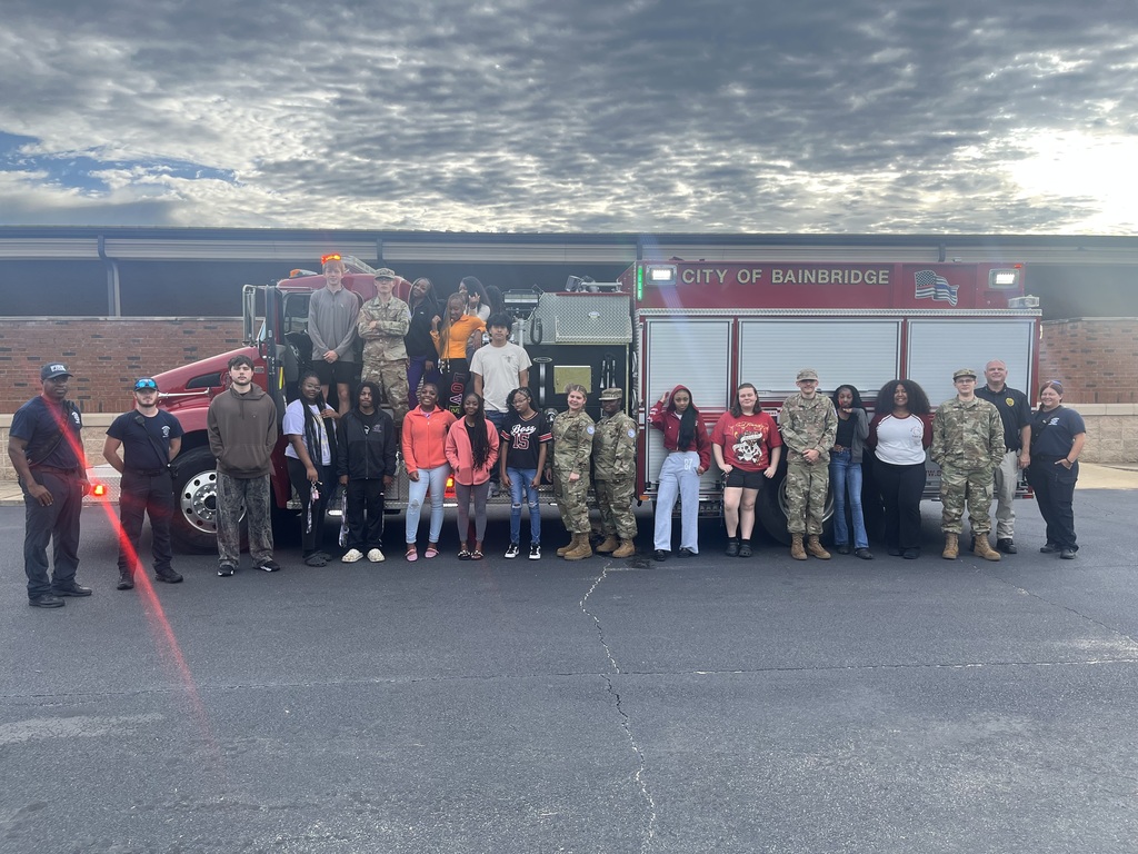 Students in the Introduction to Law and Criminal Justice Essentials classes participate in a hands-on learning experience with City of Bainbridge Fire personnel, practicing fire extinguisher use, exploring a fire truck and its equipment, and learning about fire safety, emergency response, and public safety careers.