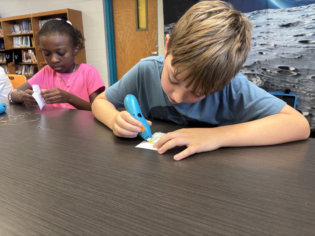 Hutto Elementary students use 3D printing pens to create designs during a hands-on Manufacturing Day activity.