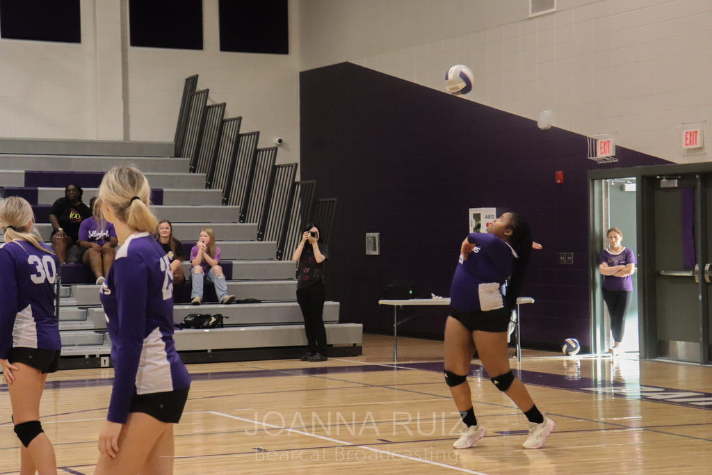 BHS player serving the volleyball
